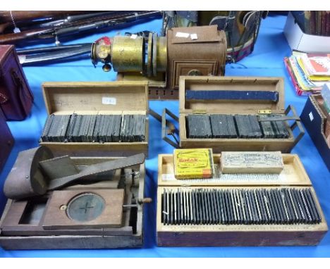 A Victorian tinplate and brass-mounted Magic Lantern, together with three large wooden boxes of approximately 180 slides, sub