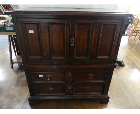 A 19th century oak Carolean style Panelled Chest, with two cupboard doors above two long drawers on bracket feet, with altera