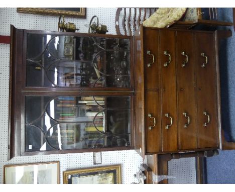 A George III mahogany Bookcase, the cornice above a pair of astragal glazed doors enclosing adjustable shelves, over a base w