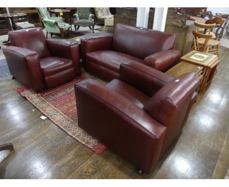 An Art Deco three piece Suite, comprising two seater sofa and two armchairs, recently re-upholstered in brown leather, all on