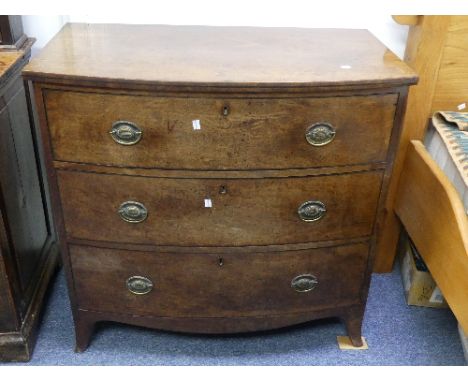 A George III mahogany bow-front Chest-of-Drawers, three long drawers with ebony stringing and later brass handles, on bracket