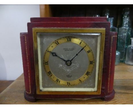 A red leather cased Elliott clock, by Swinden &amp; Sons, Birmingham, 6½in (16.5cm) wide x 5½in (14cm) high.
