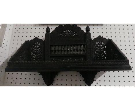 A late 19th century Anglo-Indian carved ebonised Wall Bracket, some losses, 18in (45.75cm) wide x 13in (33cm) high.