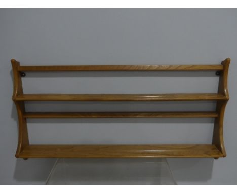 A mid 20thC Ercol two tier wall hanging Plate Rack, with holographic sticker, 38in (97cm) long, 20in (50cm) high.