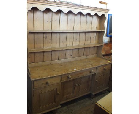 A modern Pine shelf back dresser with drawers and cupboard below