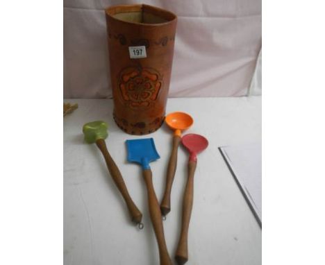 A leather kitchen utensil holder with utensils.