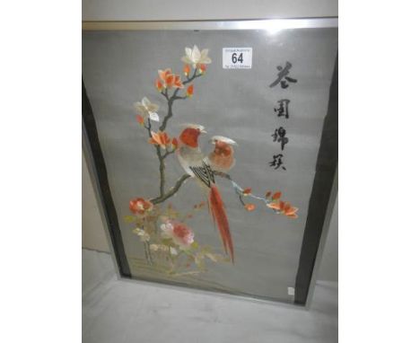 A framed and glazed signed embroidery of birds. A/F