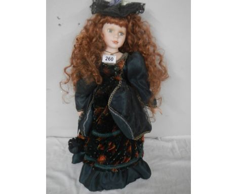 A well dressed porcelain collector's doll.