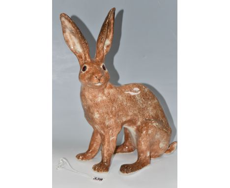 A WINSTANLEY POTTERY FIGURE OF A SEATED HARE, with mottled brown glaze, amber glass eyes, and painted marks to underside of f