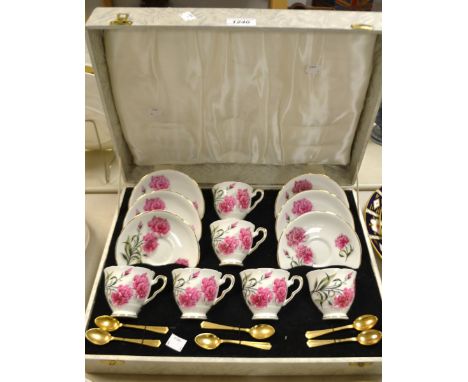 A Royal Stafford coffee service for six decorated with Pink Carnations, comprising cups, saucers and spoons, cased.