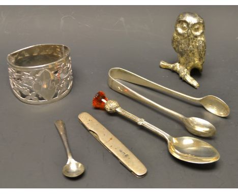 An early 20th century silver napkin, foliate fretwork arch, hallmarked; a pair of early 20th century silver sugar tongs, hall