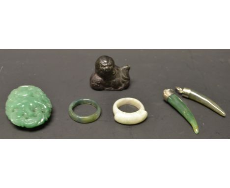 A Chinese pale jade ring; tooth shaped pendants; etc