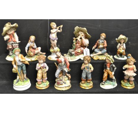 A Capodimonte figure of a cherub playing a flute; others similar of urchins,beggars and playful children;others.