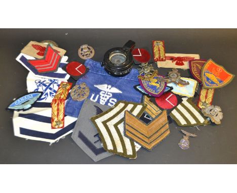 Militaria - a WWII period black lacquered compass, pearlescent dial, numbered outer ring;  Rank and regimental cloth badges, 