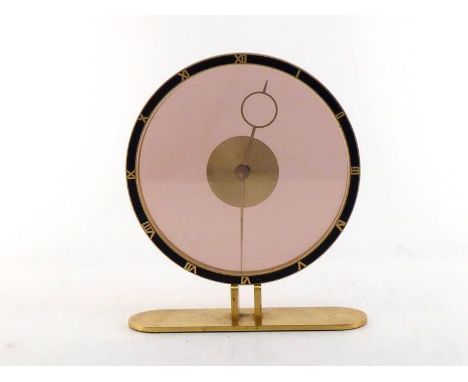 A 1930s style gilt mystery clock,the eight day key wind mechanism hidden by the disc central to the clear double glass dial e
