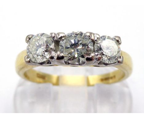 An 18 carat gold and three stone diamond ring, the three graduated brilliants totalling approx. 0.85 carat, box claw set, the