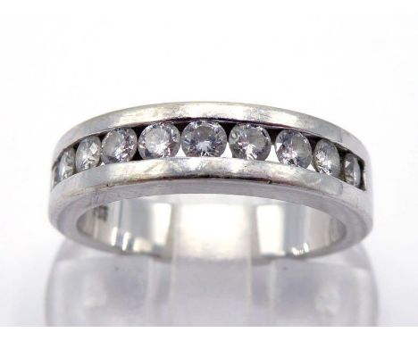 A diamond band ring, tension set with ten small brilliants totalling approx. 0.46 carats, the inner shank stamped '585', fing