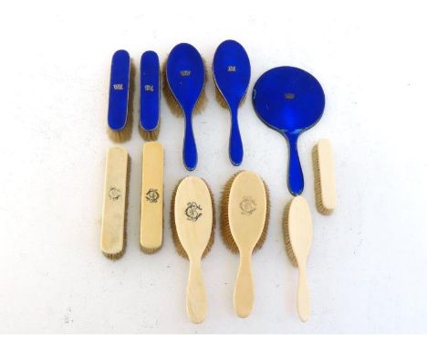 A five-piece silver and blue guilloche enamel dresing table set applied with naval coronet, by Barker Brothers, Birmingham, 1