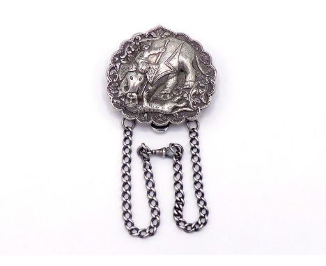 A late 19th. century Indian silver chatelaine clip featuring an elephant with mahout trampling a tiger, two chains dependent,