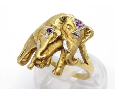 An Indian gold and ruby 'elephant' ring, depicting an adult and calf, each wearing a ruby set nettipattam, the shank stamped 