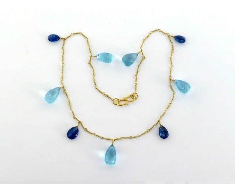 A sapphire and blue topaz necklace, the fine chain (tests 18 carat gold) set along its length with alternate briolette cut to