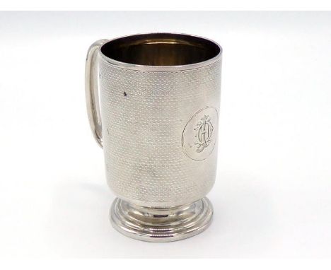 An Edwardian silver christening mug by Deakin & Francis, Birmingham, 1908, engine-turned, with "C"-shaped handle, front with 