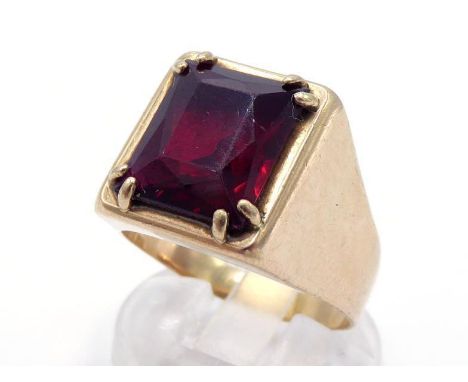 A gentleman's yellow metal (tests 18 carat gold) and synthetic ruby set ring, the mixed rectangular cut stone claw set above 