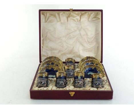 A set of six Edwardian Art Nouveau silver coffee cup holders  pierced with sinuous flowers, all by William Hutton & Sons Ltd.