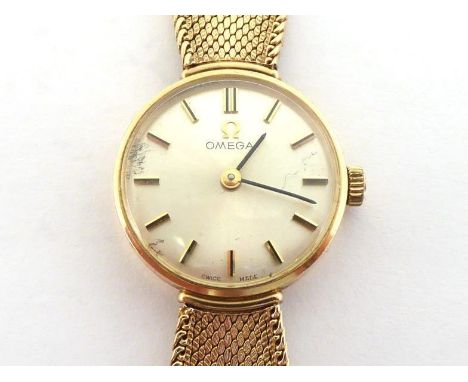 OMEGA, a 1960s lady's 9 carat gold manual wind wristwatch, the circular silvered dial with baton markers and hands, the 17 je