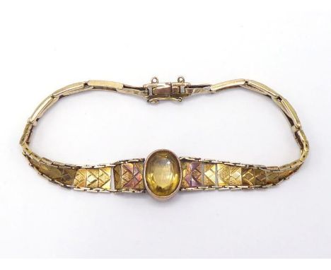 A 1940s citrine set yellow metal (tests 9 carat gold) bracelet, the central collet set oval cut citrine 13 x 9mm, to a gradua