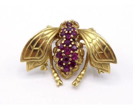 A yellow metal (tests 14 carat gold) and ruby brooch, modelled as a fly, the head, thorax and abdomen pave set with small rou