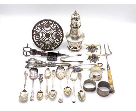 A group of silver items comprising:- a sugar caster, Birmingham, 1933; three napkin rings; a pair of Edwardian silver and ivo