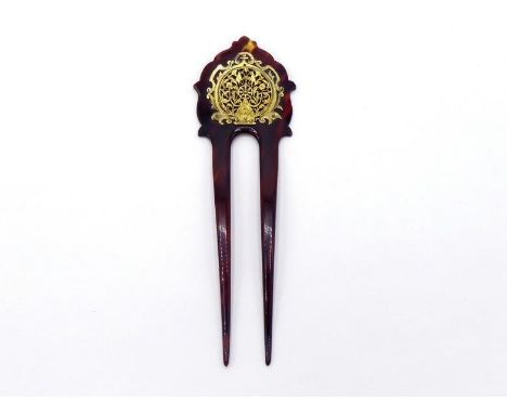 A Victorian tortoiseshell hair comb, set with a pierced and engraved balance cock from an 18th century verge pocket watch, in
