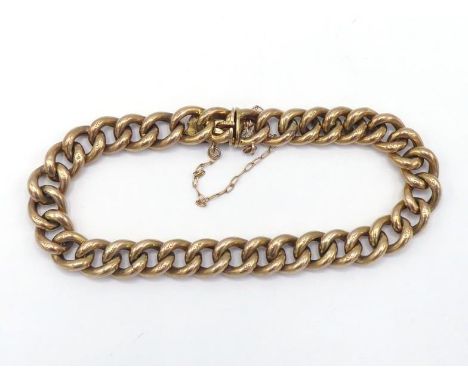 A 9 carat gold curb link bracelet, each link stamped '9c', 18 cm long, 11.8gms CONDITION: good, with safety chain 