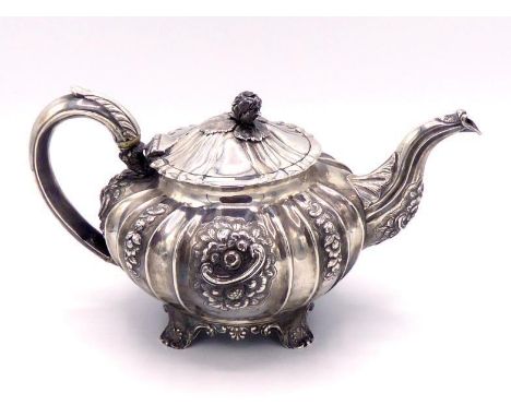 A William IV silver melon-fluted teapot by John James Keith, London, 1832, sides chased with flowers and scrolls, leaf-capped