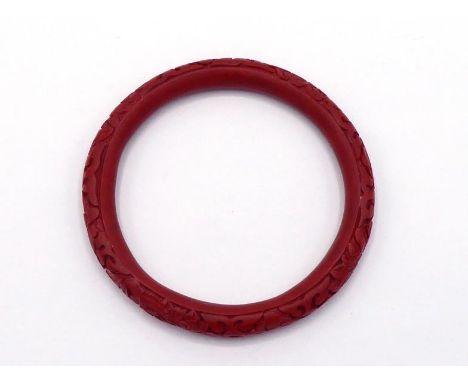 A Chinese cinnabar lacquer bangle, 6.5cm inner diameter 