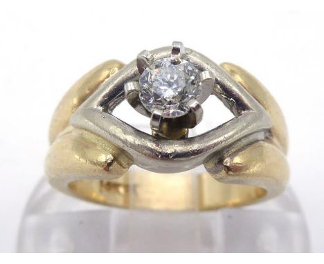 A single stone diamond ring, the central brilliant approx. 0.20 carat, claw set above a yellow shank, the shank stamped '14k'