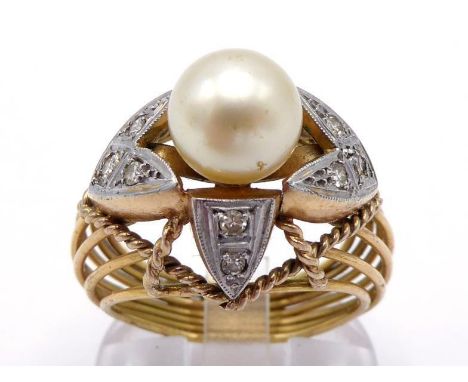 A cultured pearl and diamond ring, the central pearl 8.4mm diameter, set above a platinum flashed 'calyx', each leaf set with