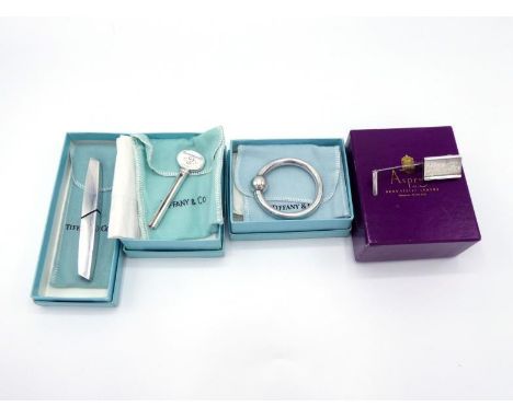 Four silver gifts, three from Tiffany & Co. and one from Asprey, all in their original boxes, one inscribed, the others initi