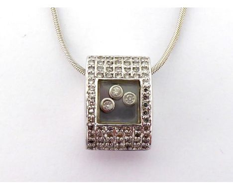 A diamond pendant, in the style of Chopard, the oval section pendant pave set overall with small brilliants, a glazed panel t
