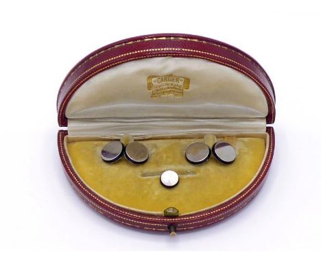 A pair of Art Deco 18 carat white gold and enamel cuff links by Henri Droguet, each plain polished circular link with a black
