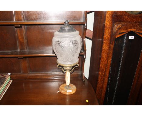 An antique onyx based lamp with glass shade