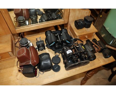A Tasco 16x50 pair of binoculars; a Zenith 7x50 pair of binoculars; an Optimax 8X30 pair of binoculars; various lenses, camer