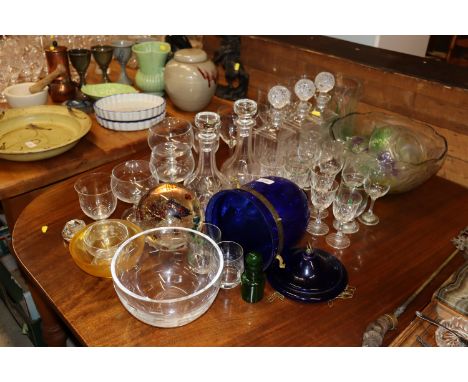 A quantity of glassware to include five decanters and stoppers, a blue glass light shade, a large paperweight decorated with 