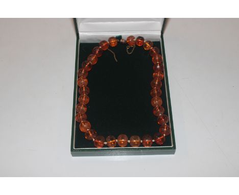 A vintage amber and yellow metal (tested as 9ct gold) necklace, approx. 35gms 