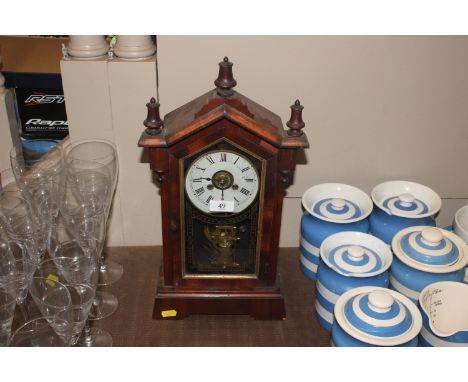 A late Victorian American two hole mantel clock with alarm movement