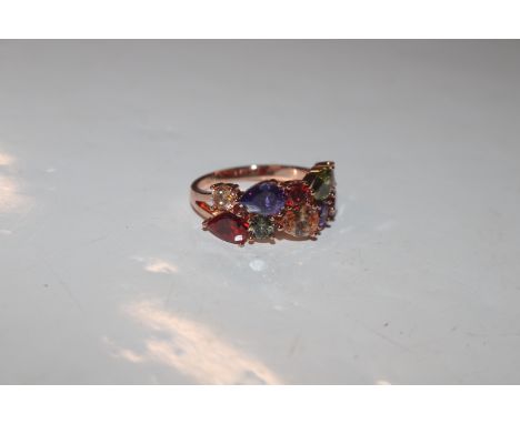 A dress ring set with multi-coloured stones, ring size R