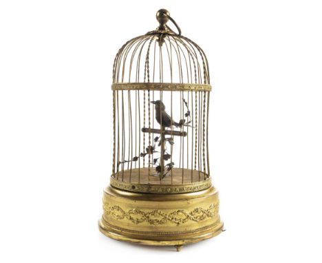 *Automaton. Early 20th century birdcage automaton,  with single singing bird perched on a branch in a gilt metal cage with ca