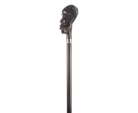 *Walking Cane. Carved walking stick,  the knop carved as an African elder the shaft with silver collar, 101.5cm long overall 