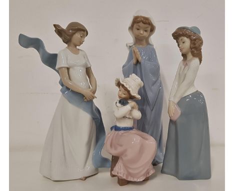 FOUR NAO FIGURINESincluding a young girl praying, 27.5cm high, a girl in a billowing gown, 25cm high, girl in a long skirt an